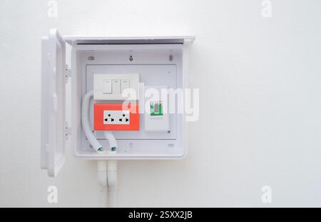 Set of old electrical, socket switch installed at white wall outside home with copy space. Home electrical switch, electrical plug concept. Stock Photo
