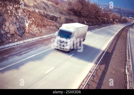 White truck on road on abstract blur background Stock Photo