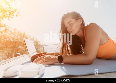 Woman Working on Laptop on a Sunny Day Stock Photo