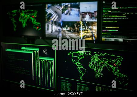 Hacker attacking servers with cyber terrorism threatening world map on screens Stock Photo