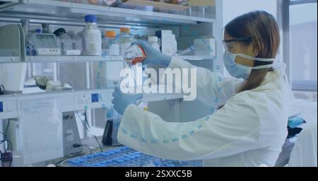 Image of numbers in circle over caucasian female scientist doing experiments in lab Stock Photo
