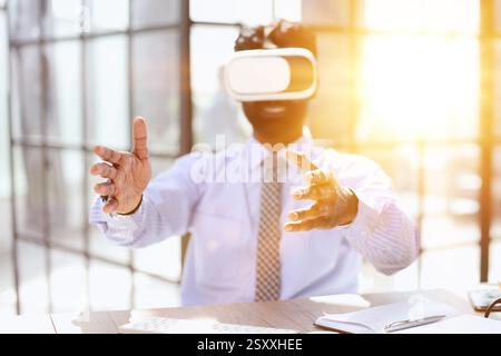 young businessman wearing virtual reality glasses in the office Stock Photo