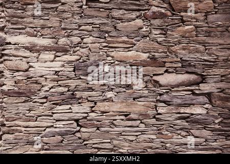 Retro stone wall texture. Natural stone wall background. Stock Photo