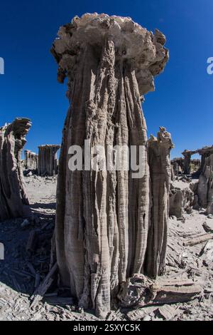Desert sand and cone shaped rock formation made of sandstone in the ...