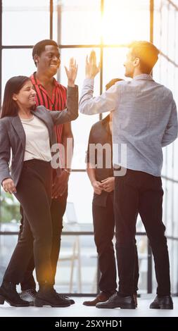 Weve done it again. Shot of a group of colleagues giving each other a high five Stock Photo