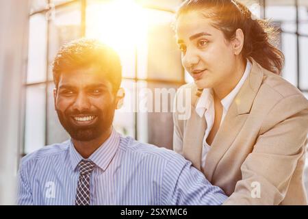 Working together on project. Two young business colleagues working on computer Stock Photo