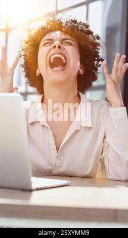 Happy excited young woman student or employee, office worker winner using laptop Stock Photo