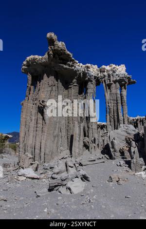 Large rock formation with a hole in the middle. The hole is surrounded by a wall of rock Stock Photo