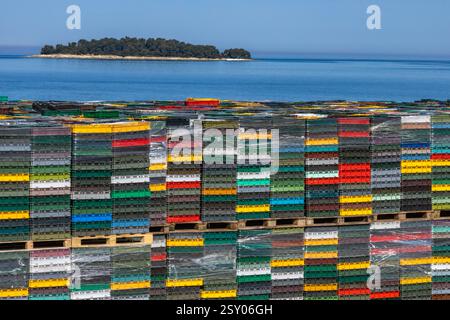 Colorful boxes stacked in a port against a blue sky, transport of goods by sea, ship unloading, attempt to smuggle goods into the European Union Stock Photo