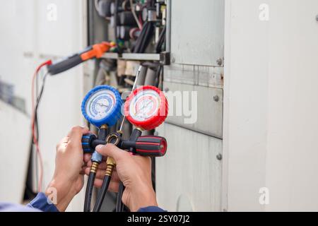 Technician checking the operation of the air conditioner. Stock Photo