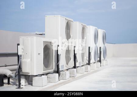 air conditioning and ventilation systems are installed on the roof of an industrial building. Stock Photo
