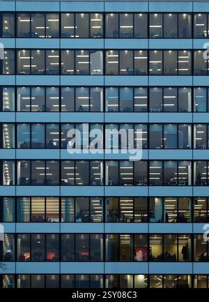 Lots Of People Working In A Lit Office Block On Multiple Floors, London, UK. Concept Office Working,Daily Grind,Modern Workplace Stock Photo