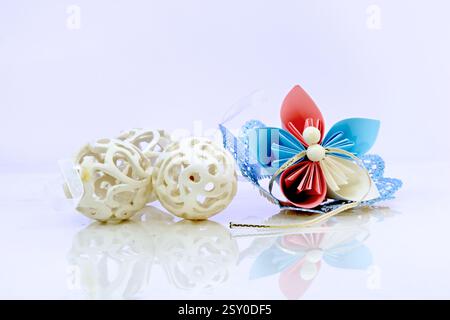 Three white plastic easter eggs and paper flower Stock Photo