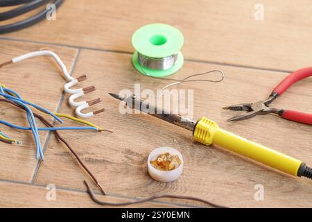 Soldering cooper wires with a soldering iron. Soldering, maintenance, repair work Stock Photo