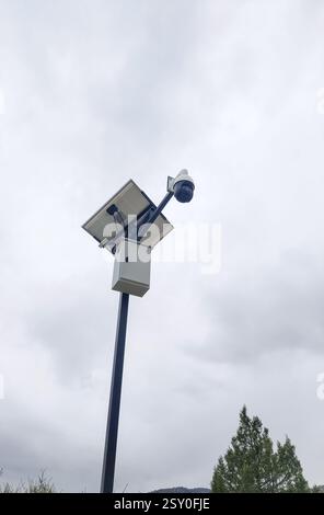 Security camera with solar panel on a pole outdoors. Stock Photo
