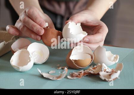 Preparing Eggshell Powder. Woman holders eggshells. Calcium supplement, cracked eggshell, natural compost ingredient, broken eggshell Stock Photo