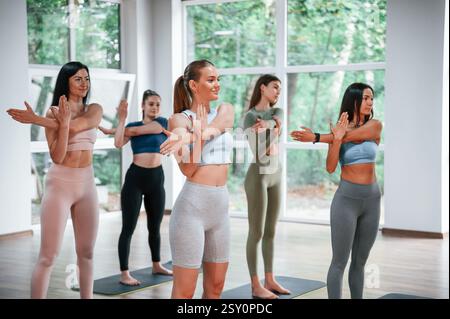 Warm up exercises. Group of women practicing fitness in the gym. Stock Photo