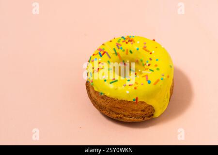 Donut with colorful sprinkles on pastel background. Top view Stock Photo