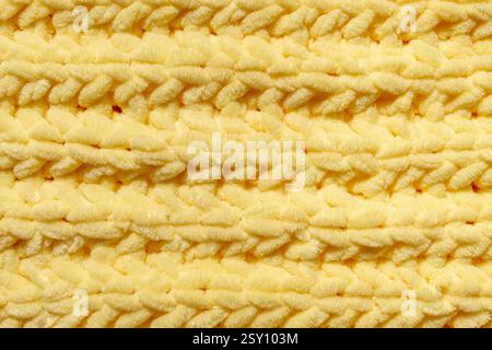 Winter wool hand-knit yellow sweater. Clothes textile background Stock Photo