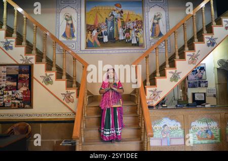 Woman standing with folded hands on the steps Rajasthan India Asia MR#704J Stock Photo