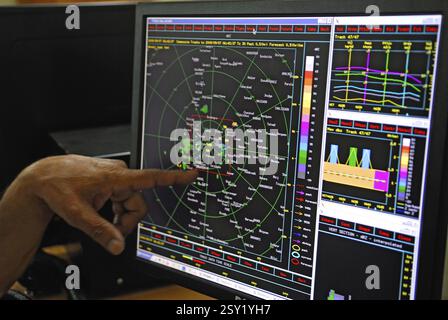Operator showing mini air traffic control setup for air cloud seeding operation, Maharashtra, India 10-September-2009 Stock Photo