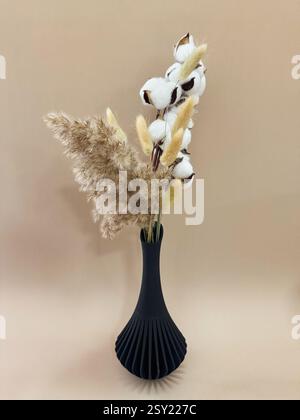 3D printed black vase home decor with reed flowers flowing geometric texture Decorative Vase For Dried Flowers made from recycled plastic  Stock Photo