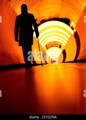 Man with a cane in a tunnel in Stockholm Stock Photo