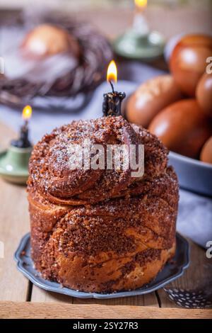 Easter cake and painted eggs, traditional Easter symbols blessed in the church. Easter cake with nut filling, eggs decorated with plant ornaments, pai Stock Photo
