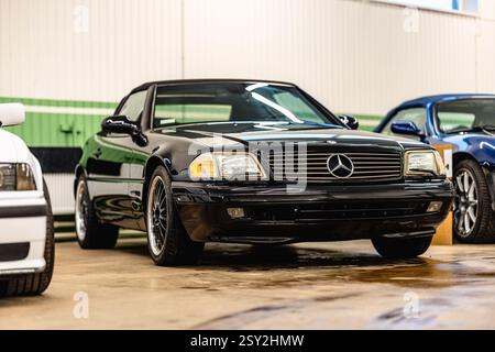 Riga, Latvia - January 31, 2025: This black MercedesBenz SLClass showcases luxury and performance, presented in pristine condition Stock Photo