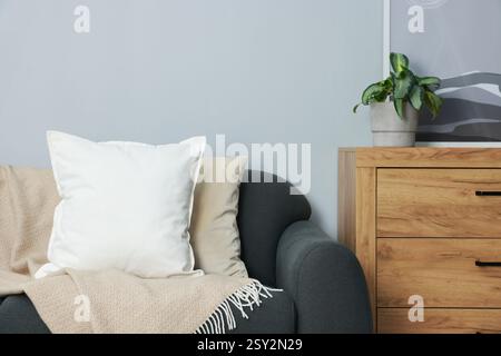 Blank soft pillow on cozy couch at home Stock Photo