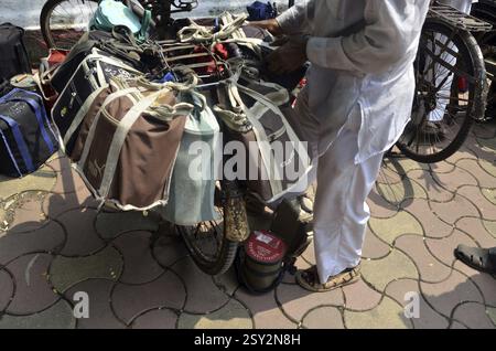 Dabbawalas carrying lunchbox on cycle at mumbai maharashtra India Stock Photo