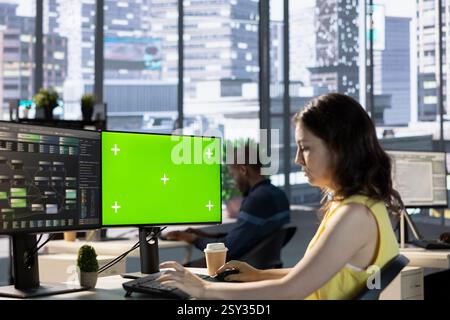 Scientist working with machine learning tech on green screen computer, advancing AI innovating autonomous systems. IT expert in office transforming data into predictive models using mockup PC Stock Photo