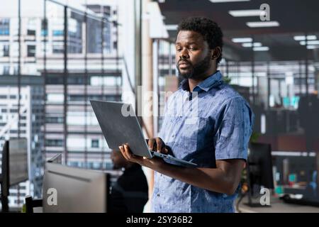 Engineer conducting detailed code review to fix bugs, identifying potential performance and technical issues with company software. IT worker debugging and optimizing code Stock Photo
