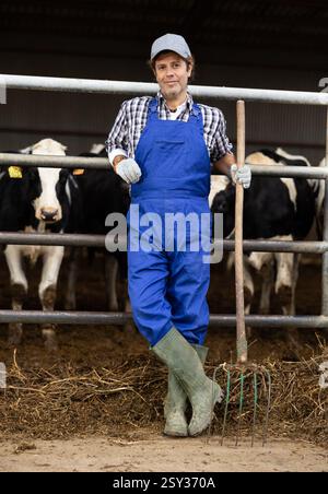 Farmer Man Rake Farmer man stands with rake at cow farm Stock Photo - Alamy