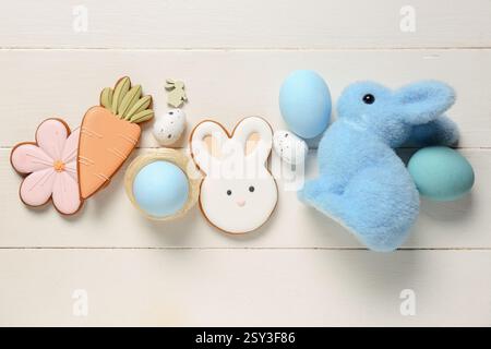 Decorative bunny, eggs and Easter cookies on white wooden background Stock Photo