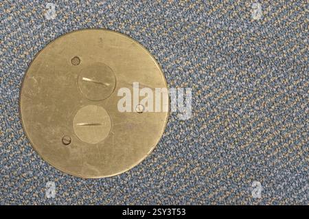 Brass plate on a carpeted floor Stock Photo