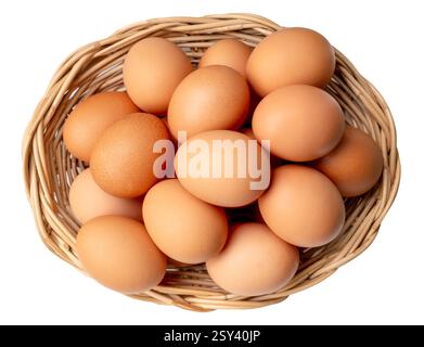 Top view of large group of chicken eggs or hen eggs in stack in wicker basket is isolated on white background with clipping path. Stock Photo