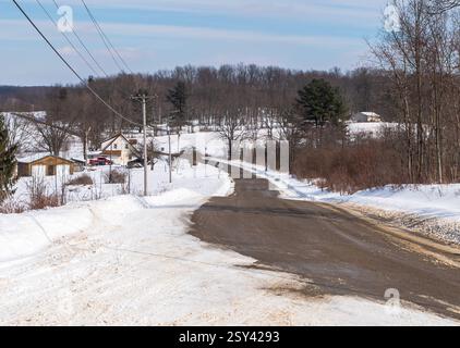 A winding rural road through the woods in Deerfield Township, Pennsylvania, USA Stock Photo
