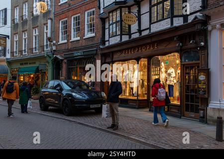 Shoppers in Cambridge town centre in the early evening at Christmas. England, UK Stock Photo
