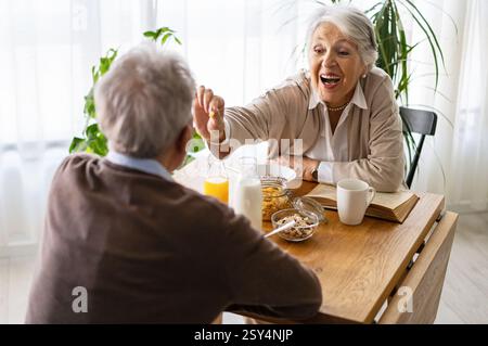 Senior happy couple in love together smiling and having fun in kitchen Stock Photo