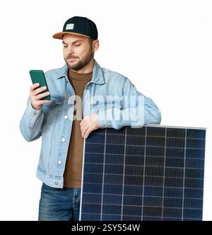 Cutout modern man standing next to solar panel and using his smart phone Stock Photo
