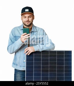 Isolated modern man standing next to solar panel and using his smart phone Stock Photo