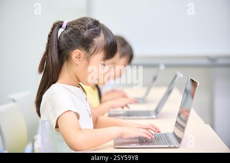 Japanese kids using laptops Stock Photo