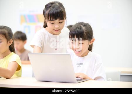 Japanese kids using laptops Stock Photo