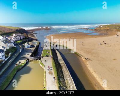 Bude, Cornwall, England, UK - 22 February 2025: Aerial view of the Bude Canal with the old lock and lock gates alongside the beach. Stock Photo