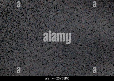 Closeup view of black dotted texture on a dark gray surface background Stock Photo