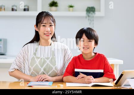 Japanese Mother And Son Working On Homework Stock Photo