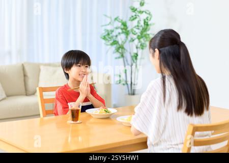 Japanese Mother And Son Eating Together At Home Stock Photo