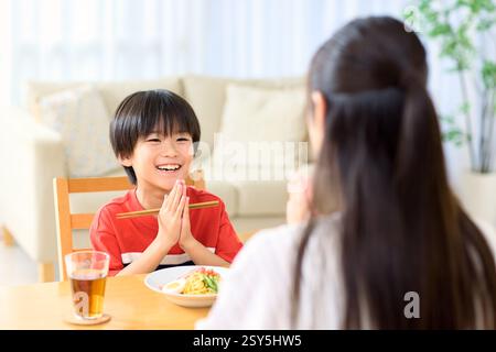 Japanese Mother And Son Eating Together At Home Stock Photo