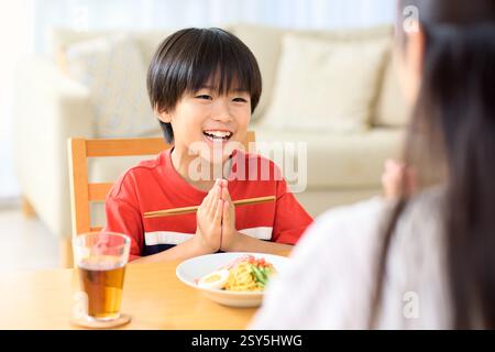 Japanese Mother And Son Eating Together At Home Stock Photo